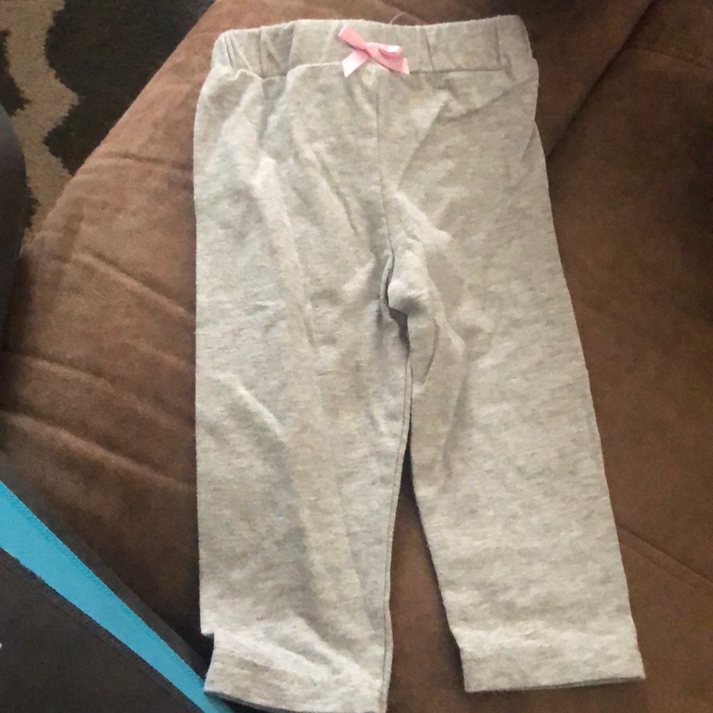 Gray pants with a pink bow in front